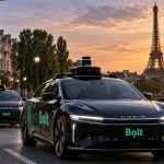 Illustration of a fleet of autonomous ride-hailing cars travelling through a European city without visible drivers.