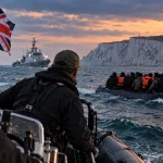 Private boat approaching a migrant dinghy in the English Channel near the British coast