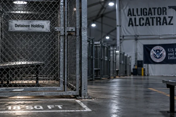 Empty metal detention enclosure inside a stark temporary immigration facility, illustrating federal findings about conditions at Alligator Alcatraz.