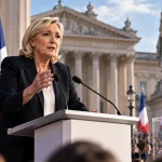 Illustration of Marine Le Pen addressing a political event in France beside a ballot box.