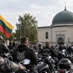 Illustration of motorcyclists gathered outside a mosque in Lithuania while police monitor the scene.