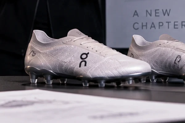 Editorial illustration of football boots and product-development materials representing On's expansion into football.