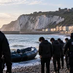 AI-generated editorial illustration representing a small migrant dinghy reaching the coast at Folkestone and subsequent border enforcement response.