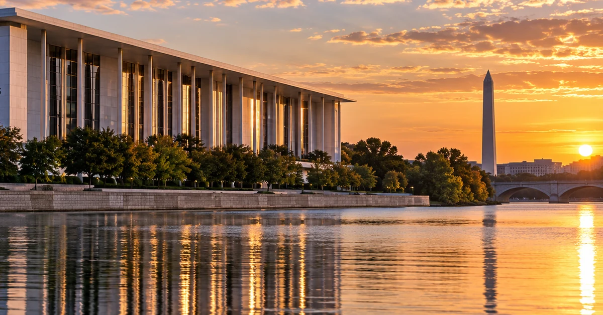The Kennedy Center beside the Potomac River in Washington DC at sunset, illustrating the dispute over its renovation and naming.