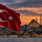Turkish flag overlooking Istanbul and a large mosque at sunset